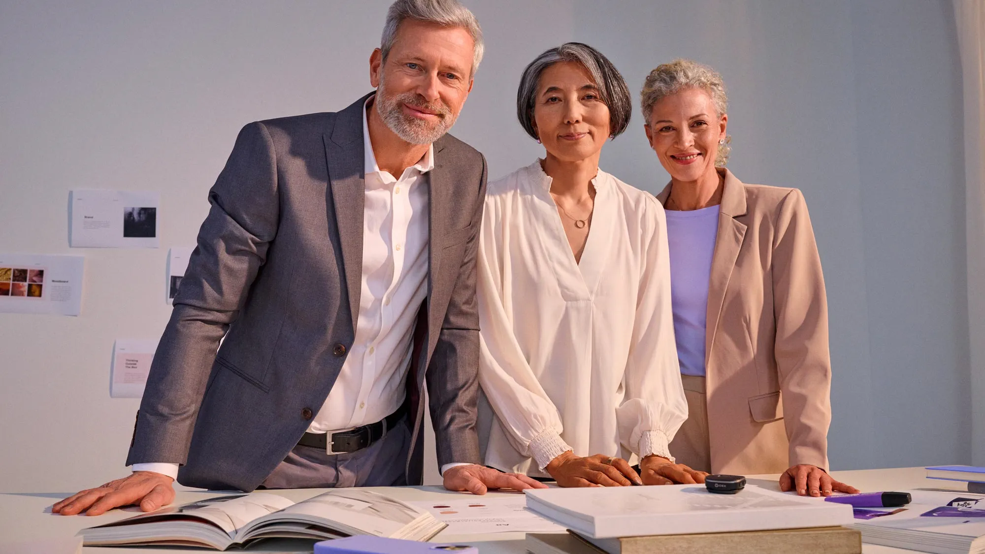 Business meeting scene, participants wearing hearing aids.