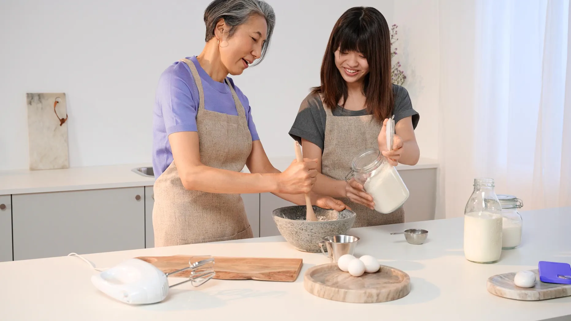Mother and daughter cooking in a hearing-friendly kitchen space