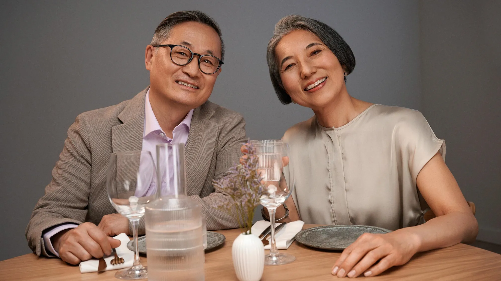 Couple having dinner, wearing hearing aids