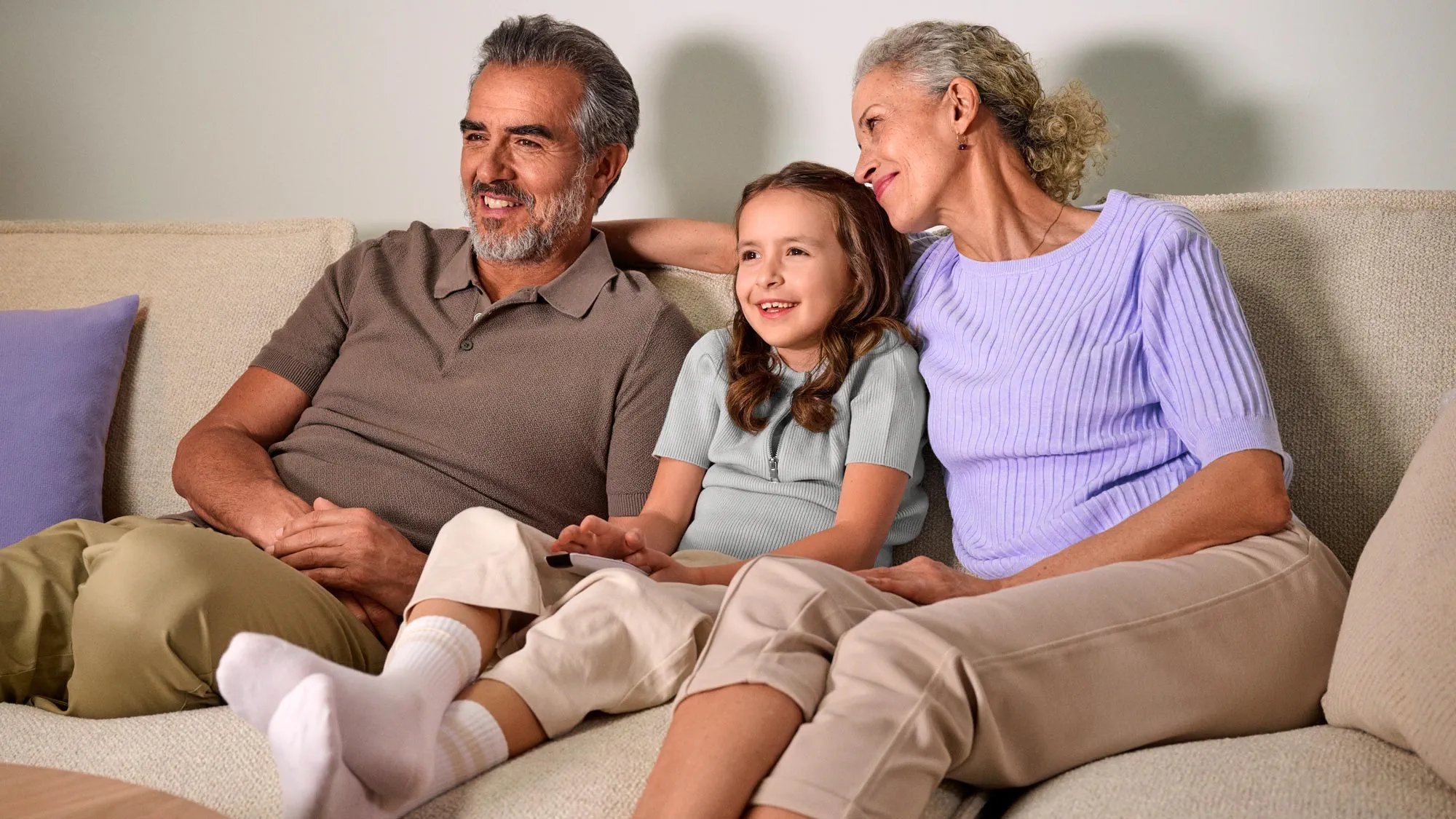 family watching tv, wearing hearing aids