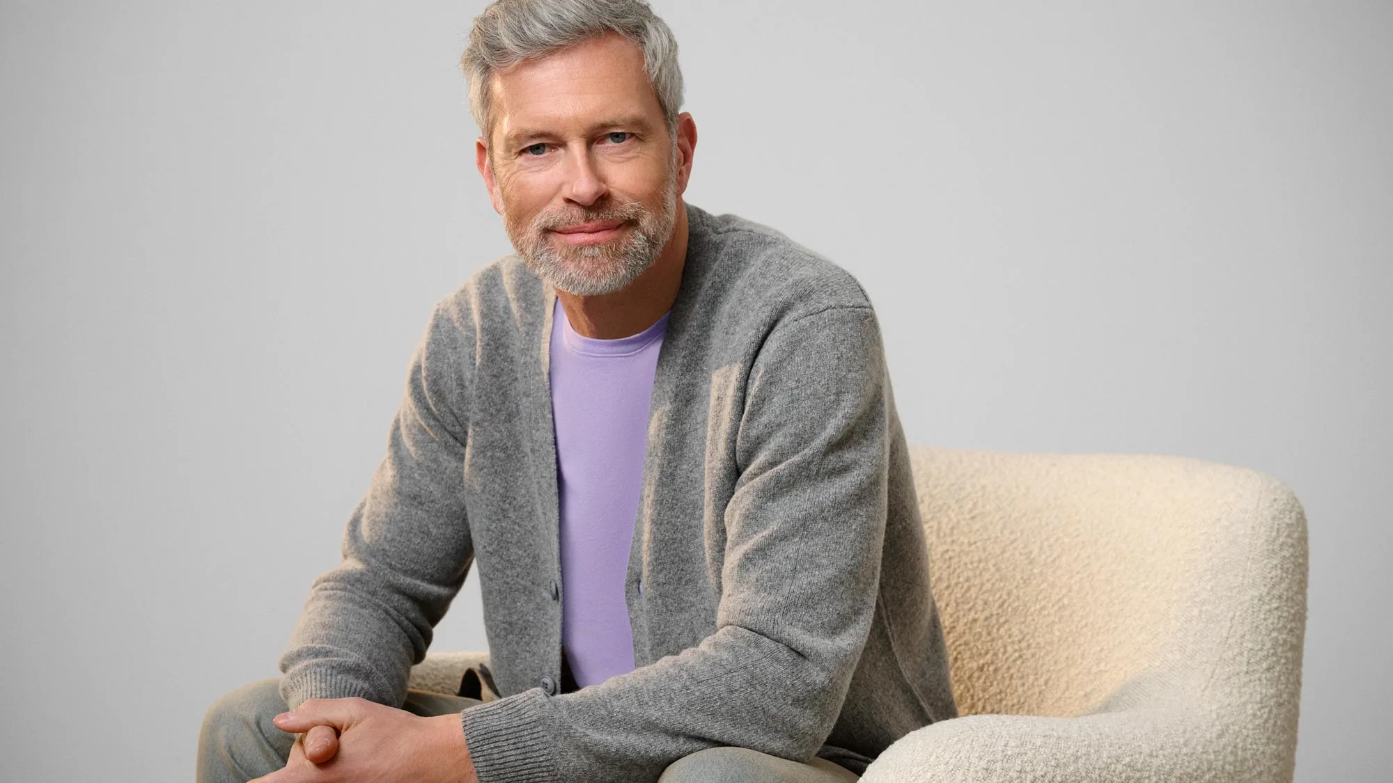 Calm man staring, reflecting on hearing loss.