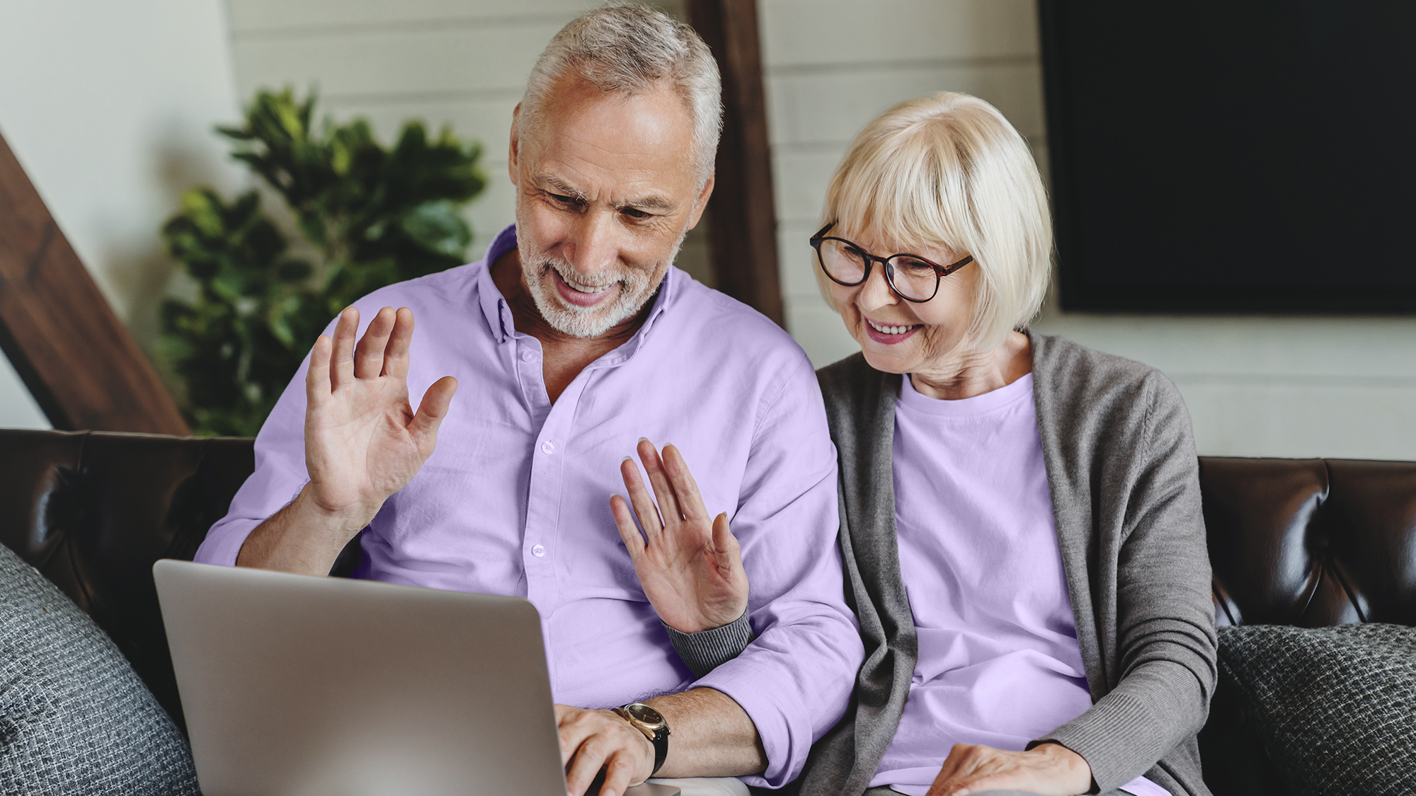 Couple engaging in aural rehabilitation via a video call on a laptop.