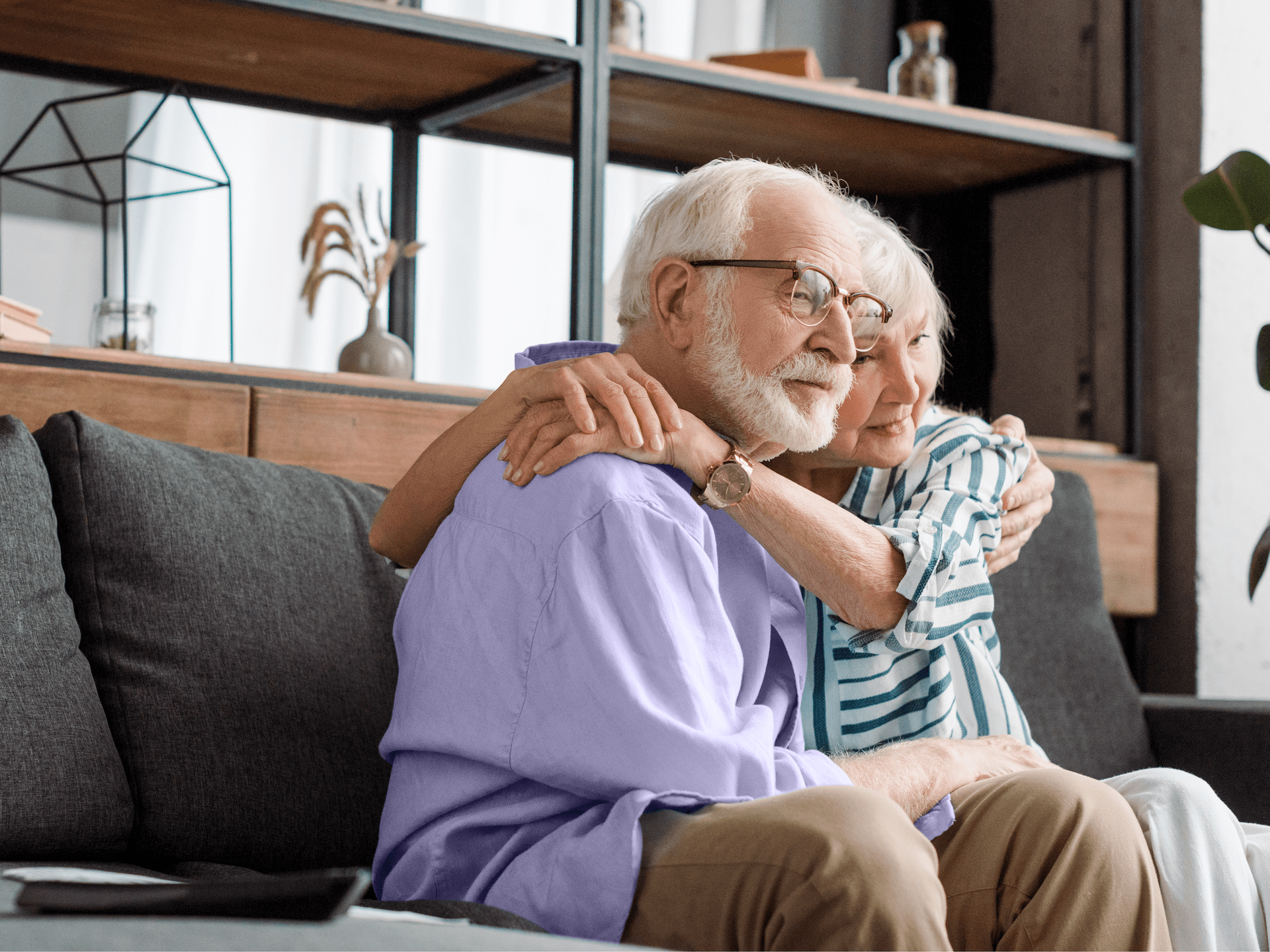 Elderly coup0le watching TV with hearing aids