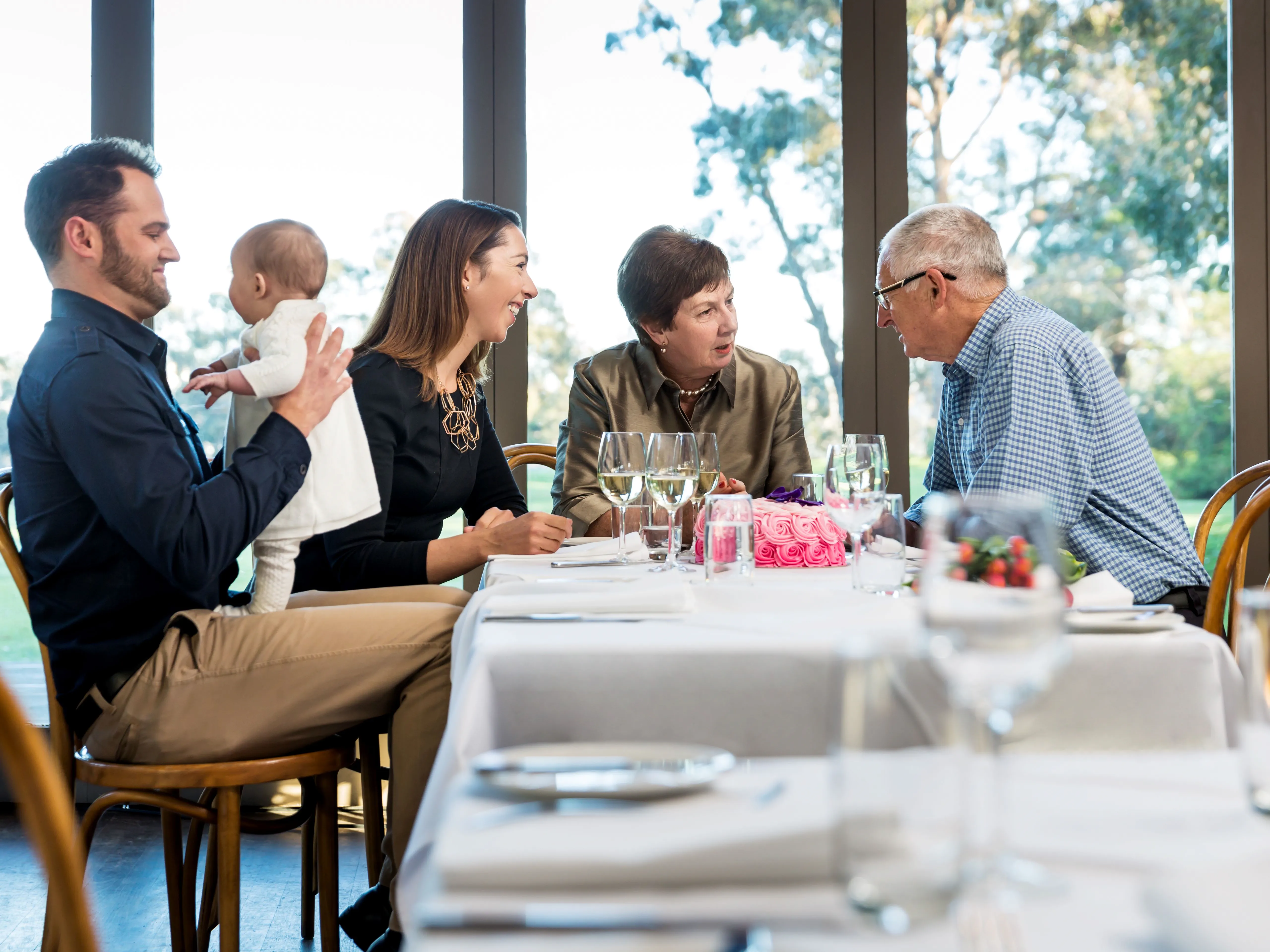 Family having dinner at a restaurant using hearing aids