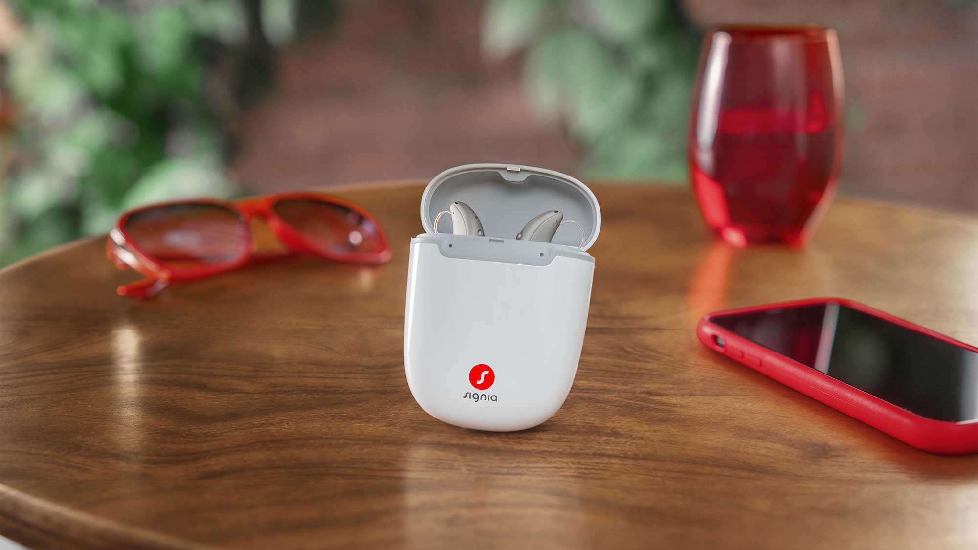 Signia Pure Charge&Go Max hearing aids placed in an open charging case, showcasing modern design and hearing-loss support.