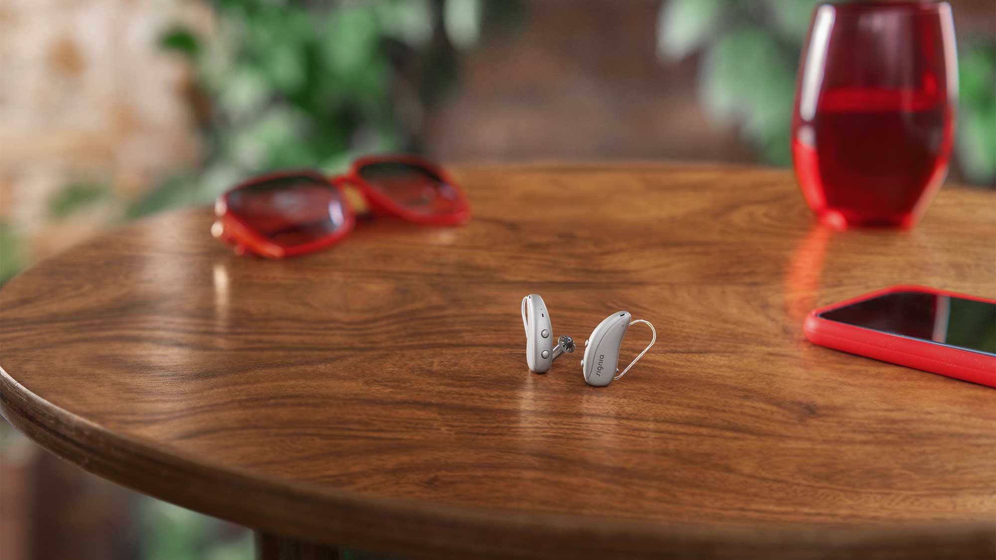 Signia Pure Charge&Go Max hearing aids resting on a table, highlighting sleek design and hearing-loss support.