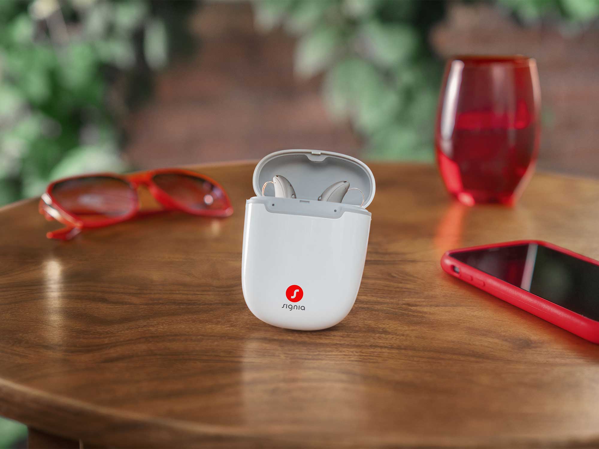 Signia Pure Charge&Go Max hearing aids placed in an open charging case, showcasing modern design and hearing-loss support.