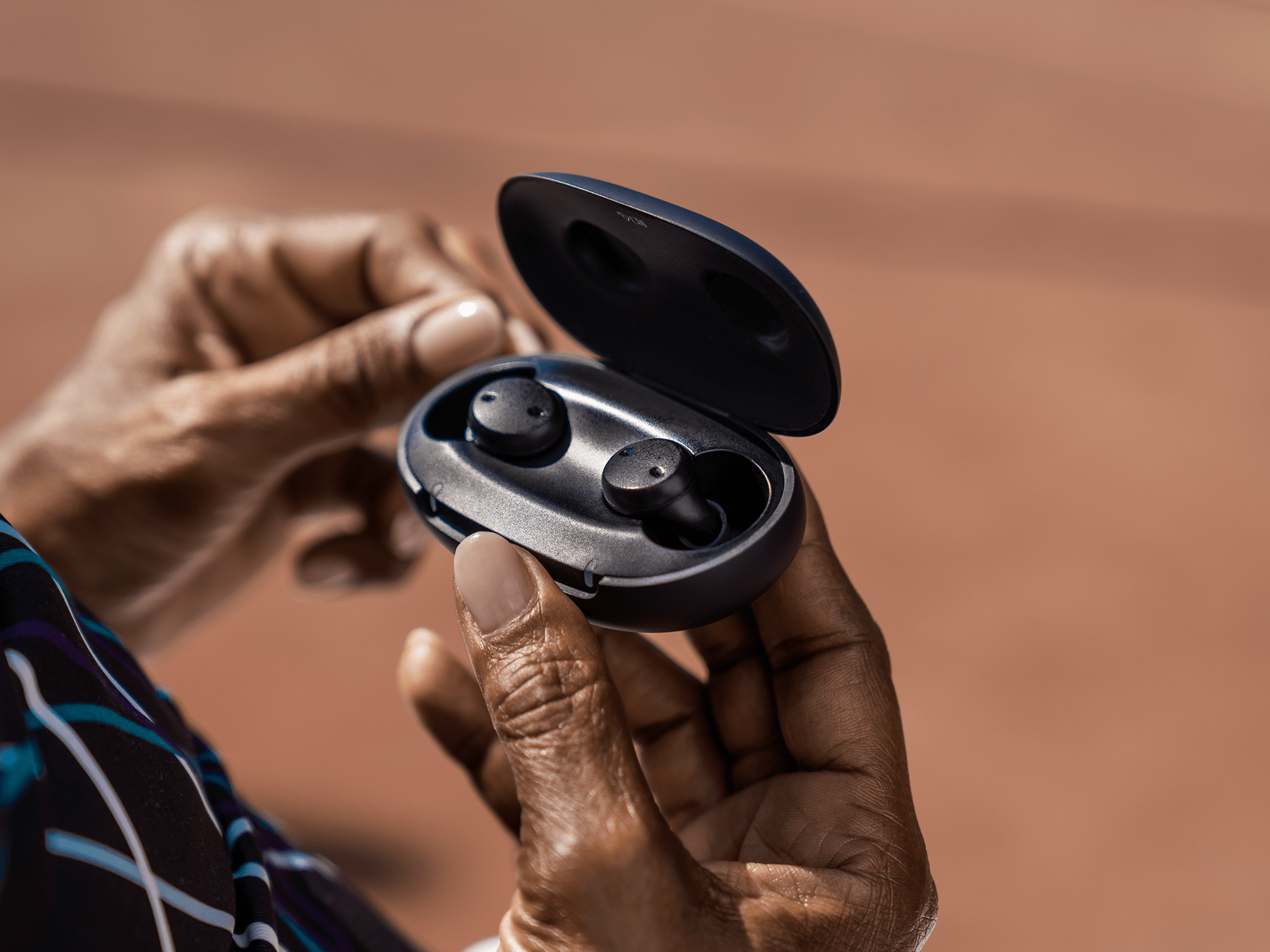 Sony's cre-e10 over-the-counter self-fitting hearing aids with a portable smart case.