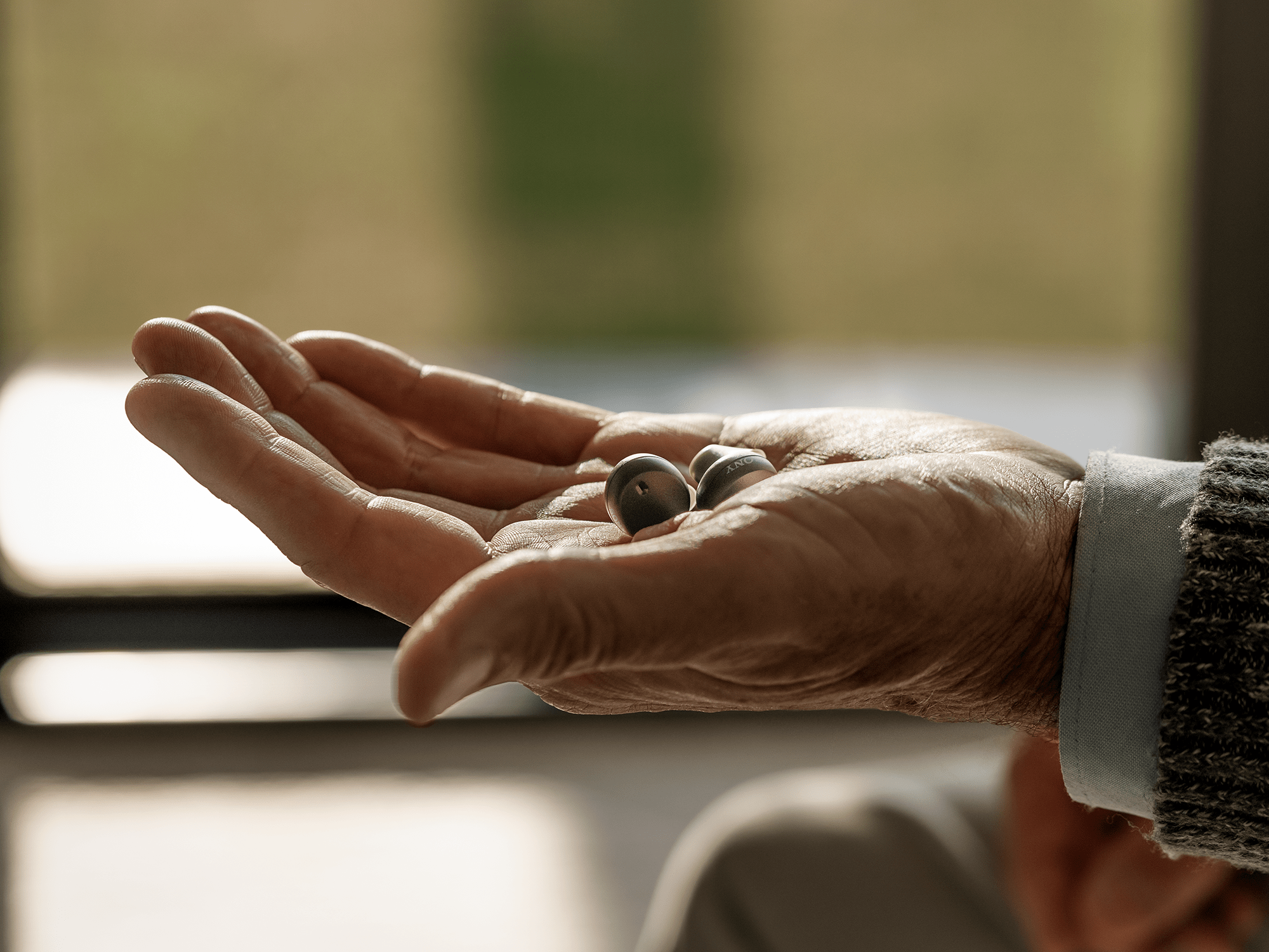 Sony's cre-e10 over-the-counter self-fitting earbud hearing aids in an earbud design. Doesn't look like a hearing aid.