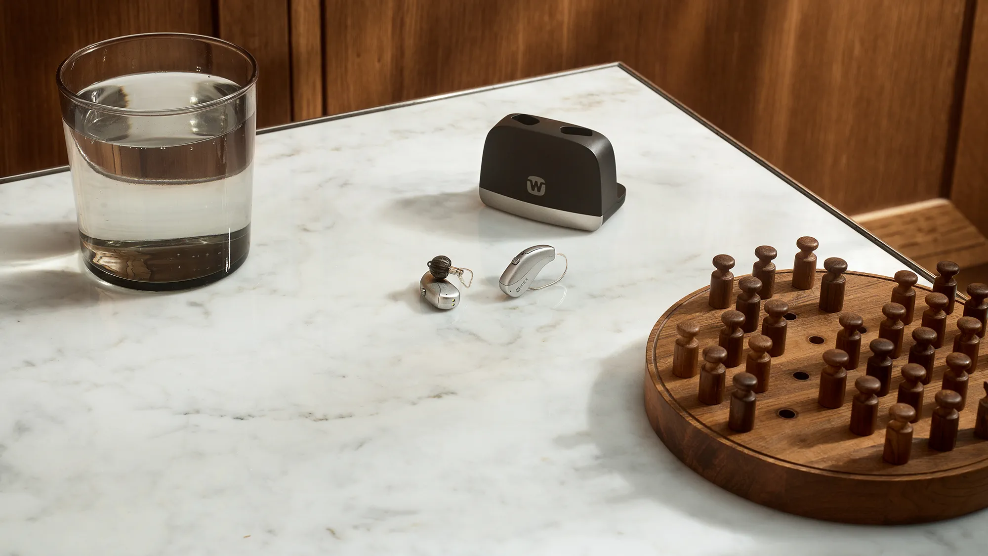 Widex Allure hearing aids laying on coffee table
