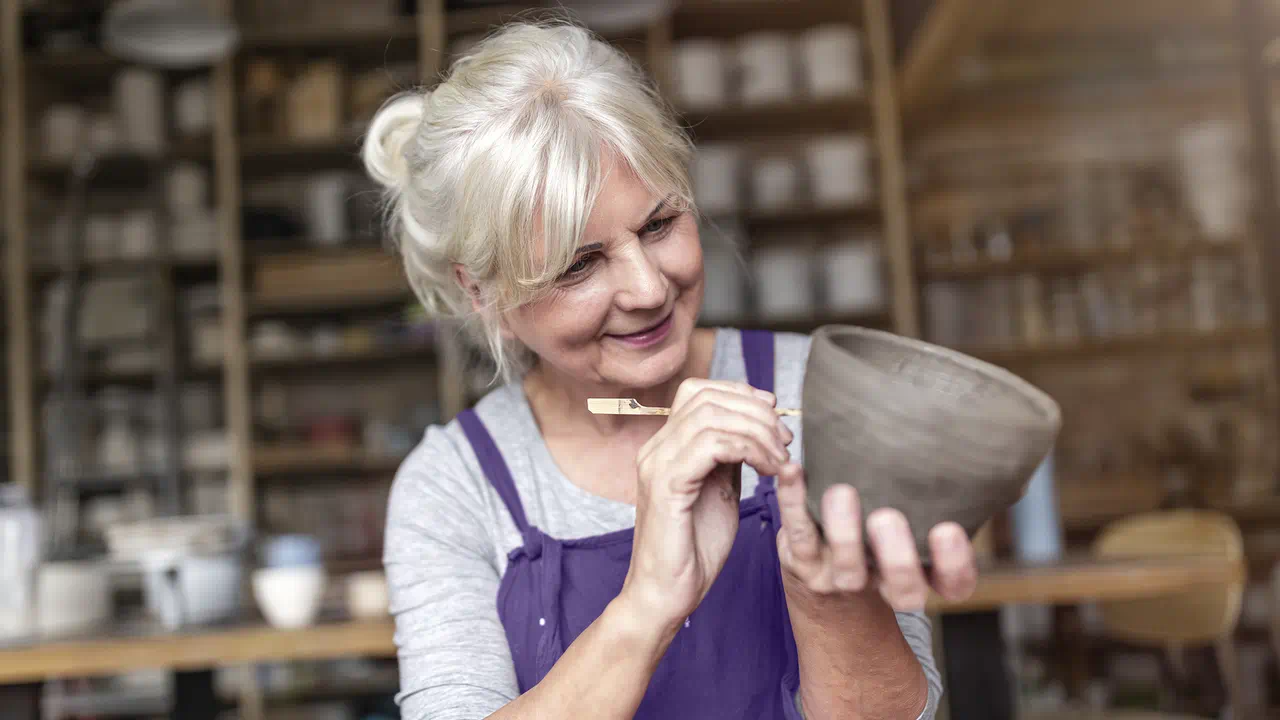 Female ceramist wearing custom hearing aids