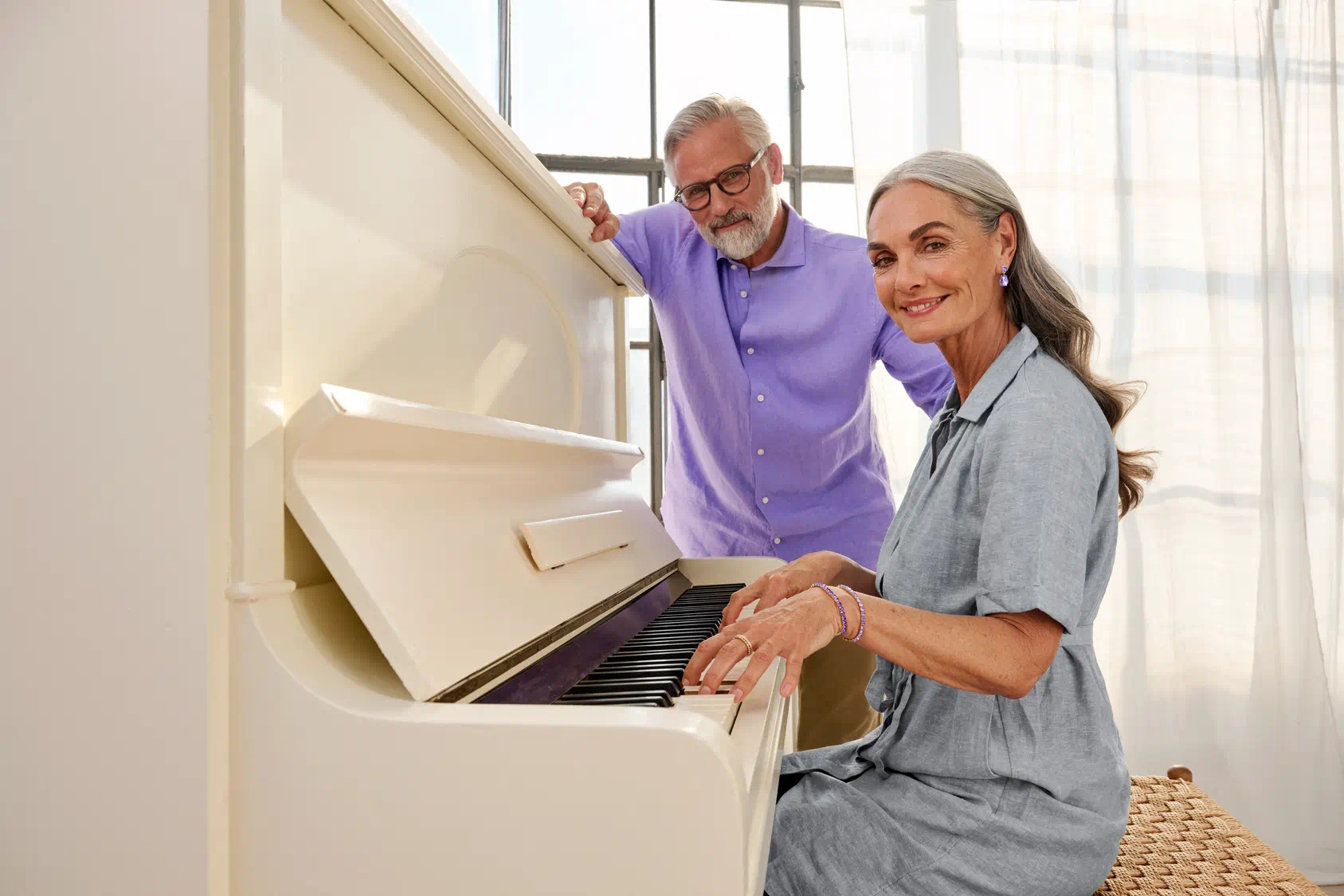 woman playing piano with hearing aids