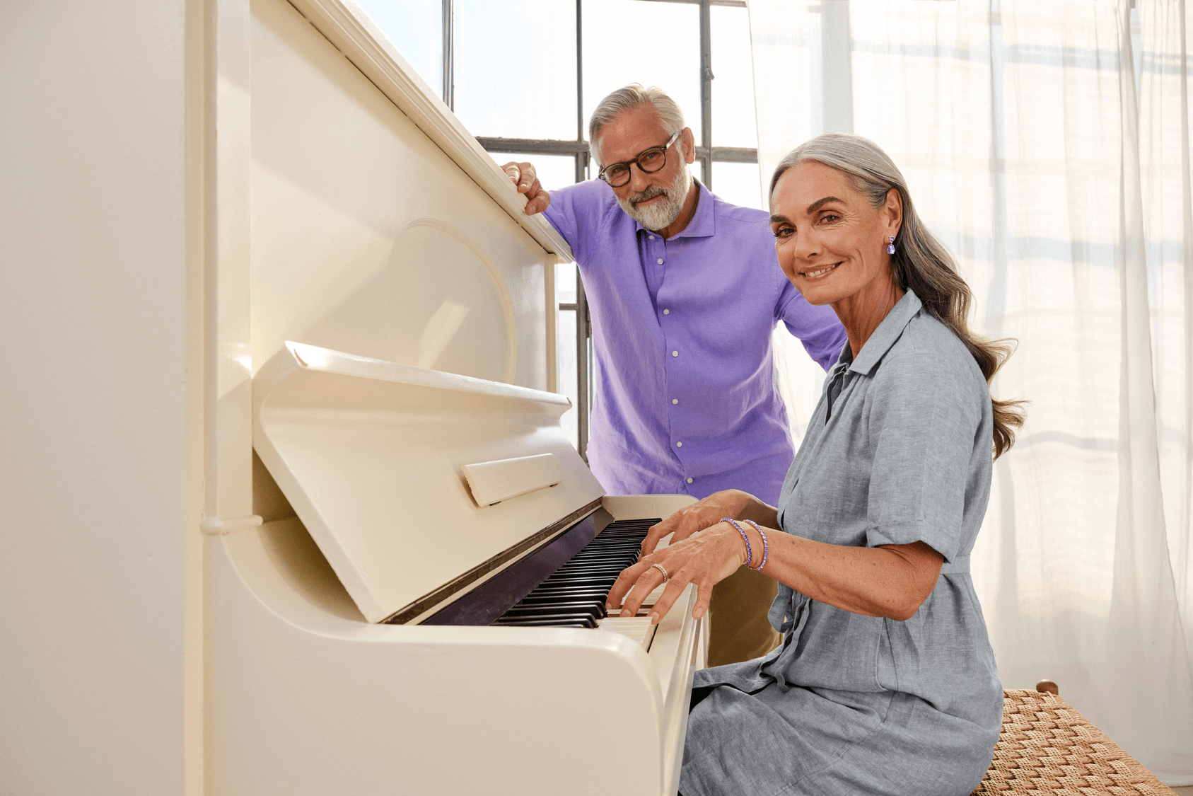 woman playing piano with hearing aids