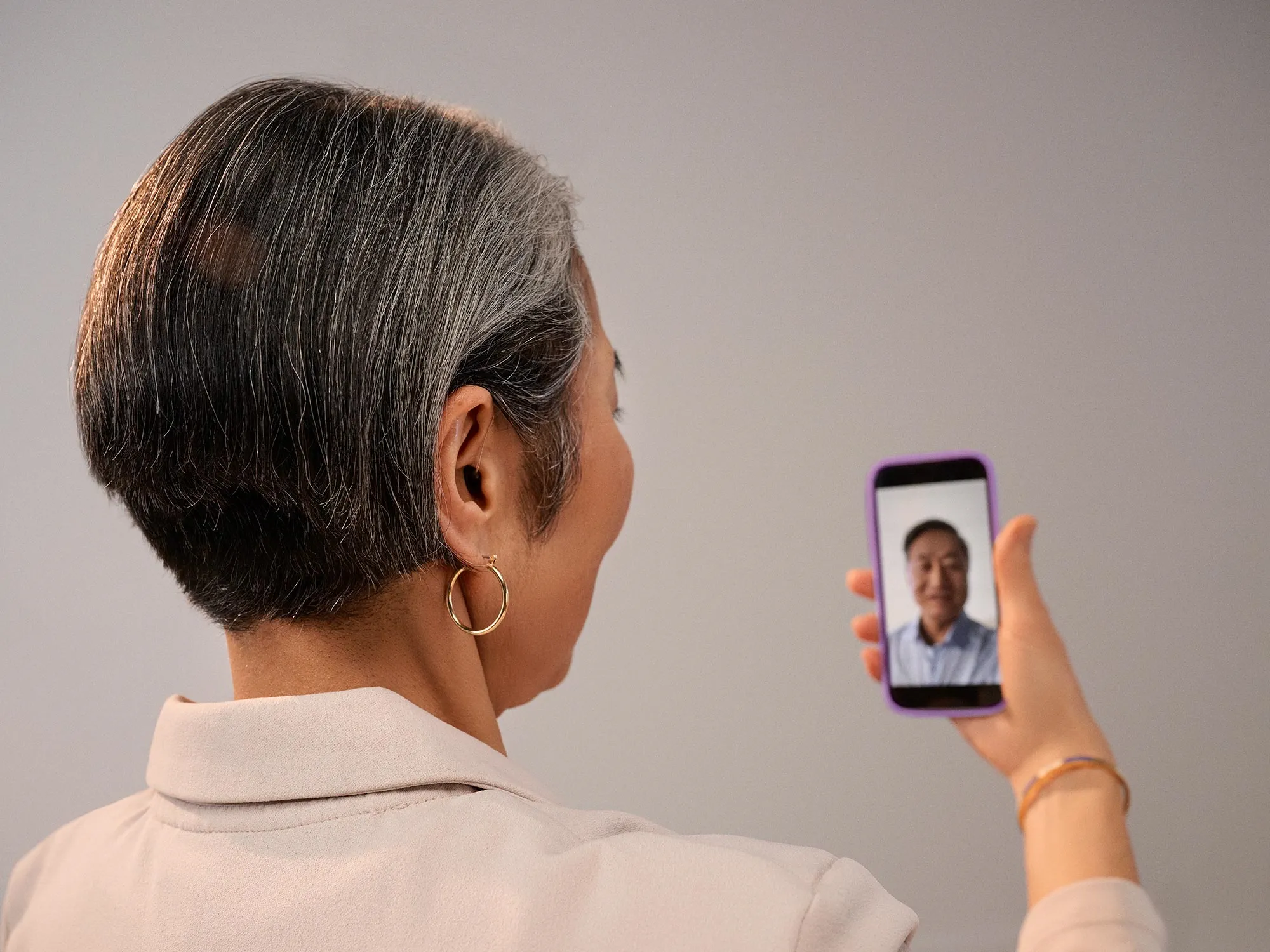 woman on a phone, having video call with hearing aids