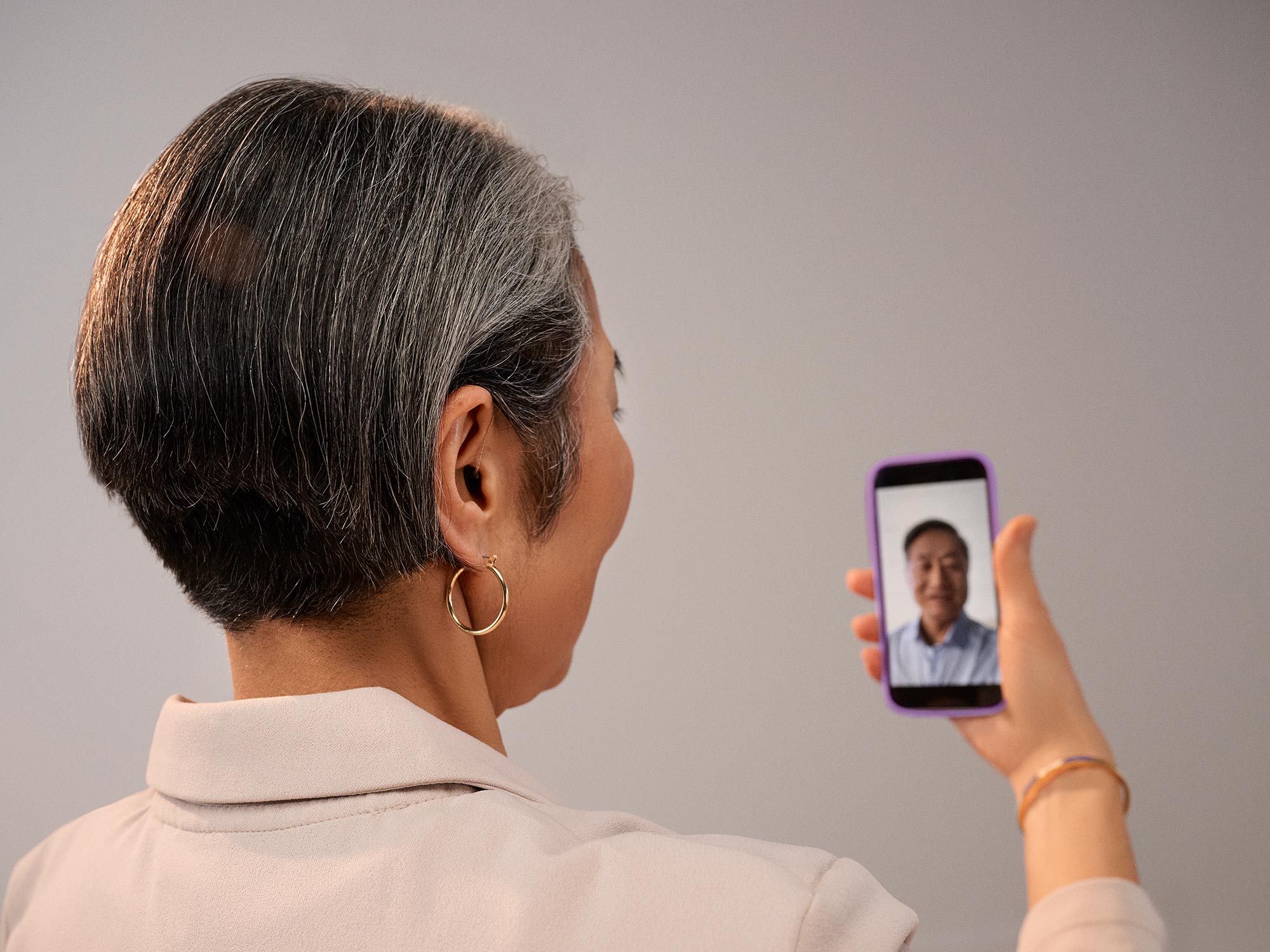 woman on a phone, having video call with hearing aids