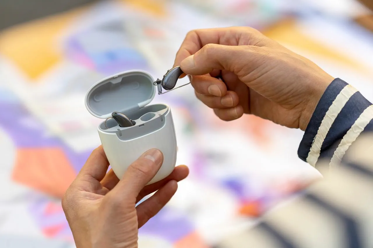 A hand holding Signia Pure Charge&Go IX Signia Hearing aids