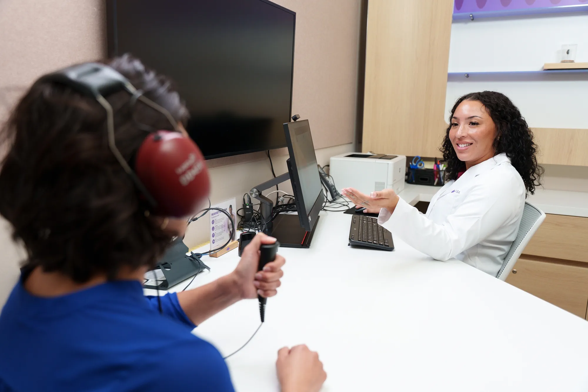 woman taking hearing test at hearusa