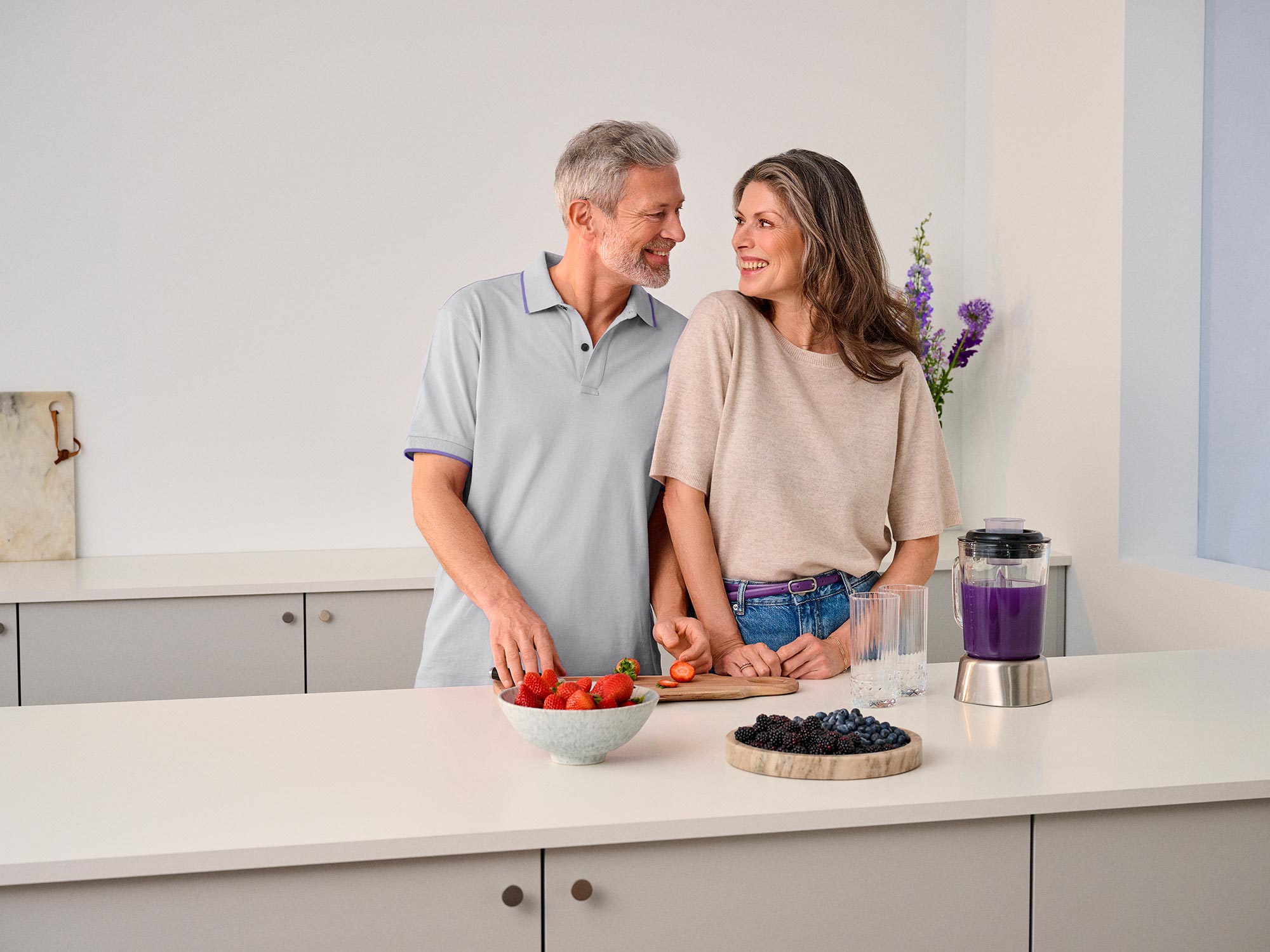 couple in kitchen cooking hearing aids 