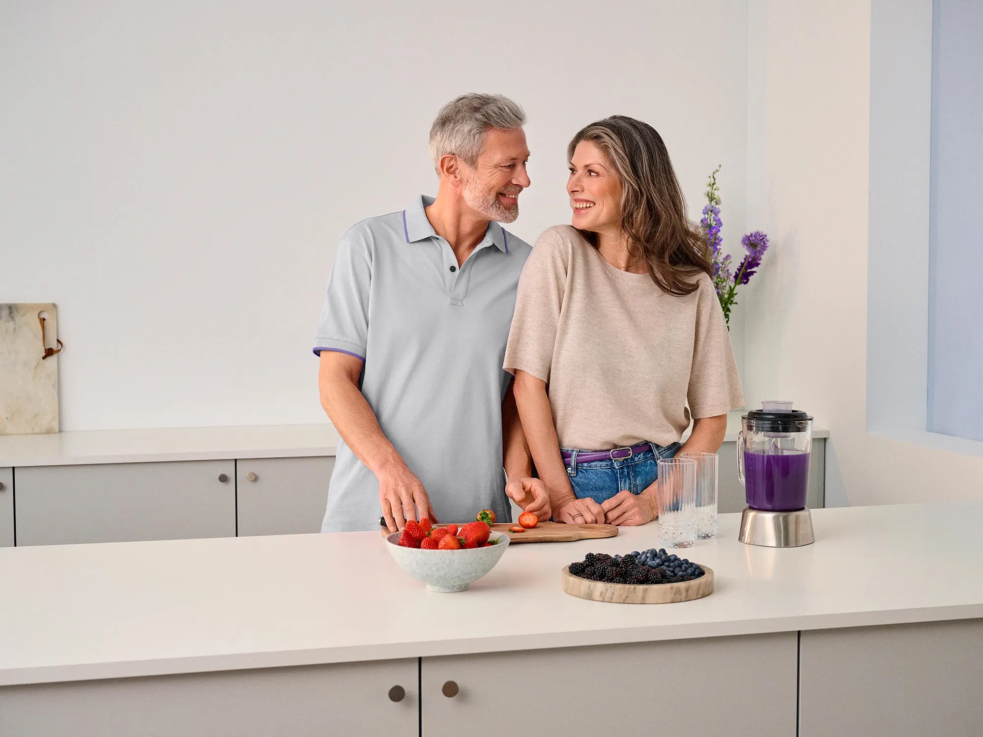 couple in kitchen cooking hearing aids 