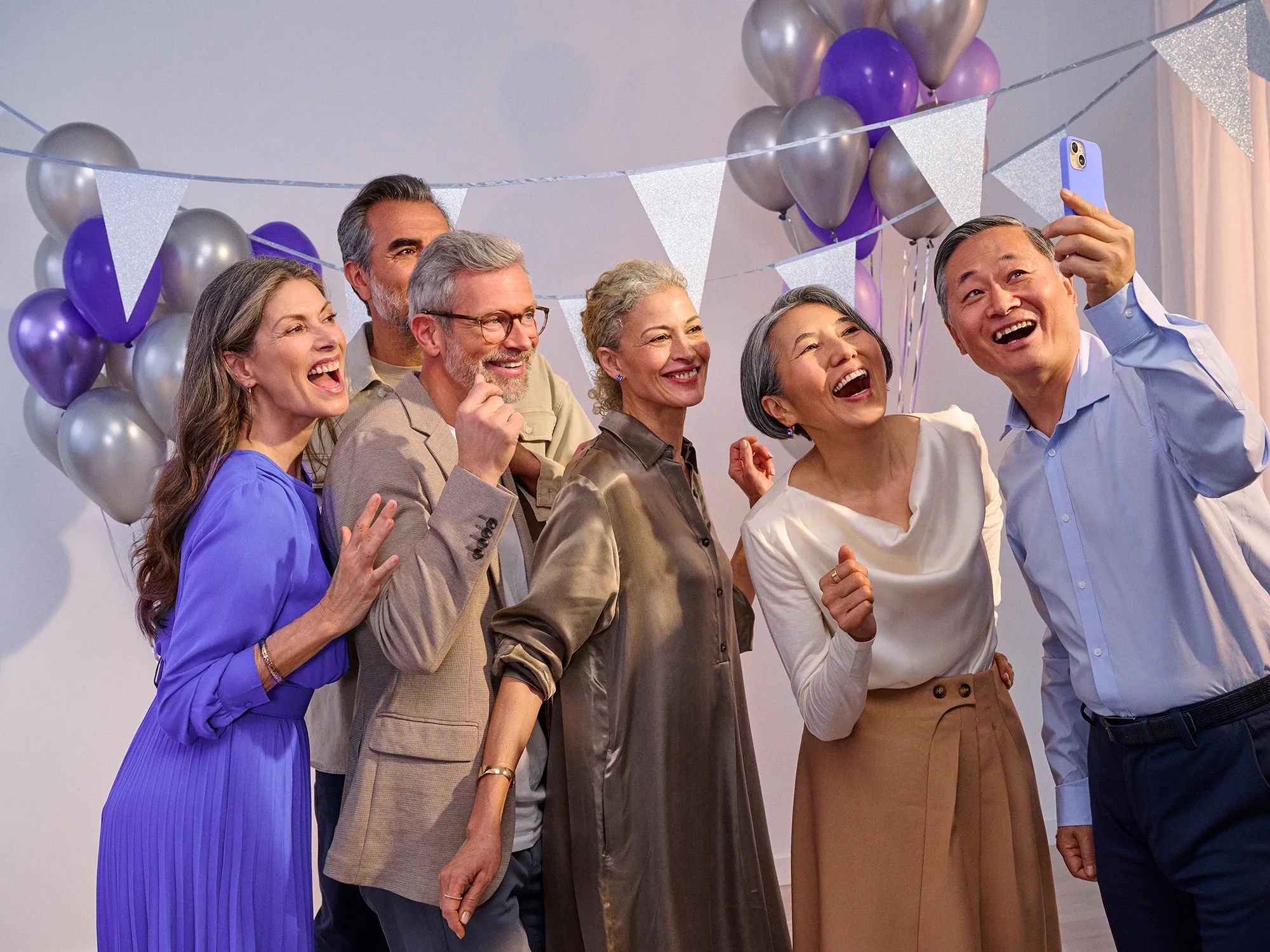 group of friends celebrating a birthday, wearing hearing aids