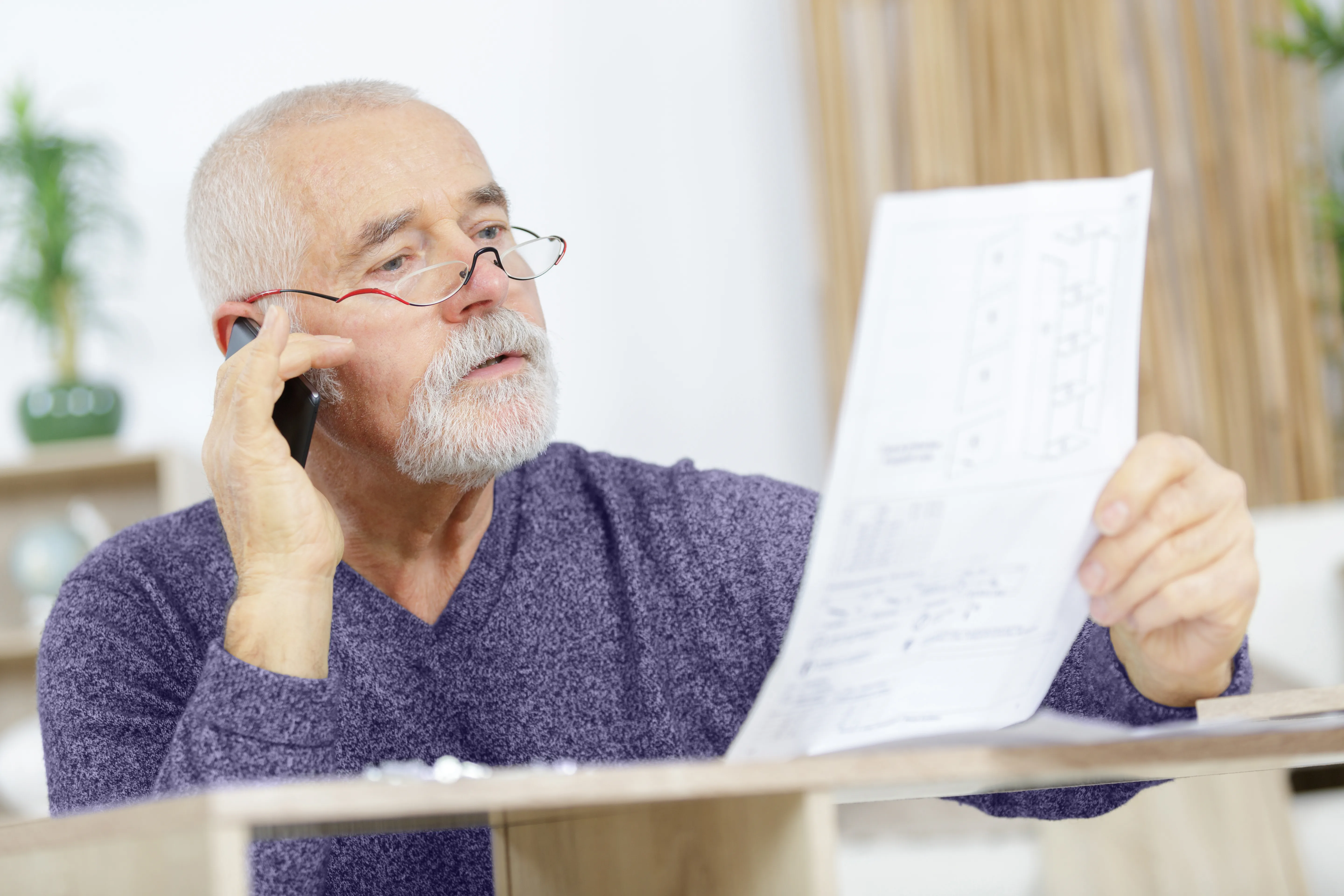 Elderly man reading a book