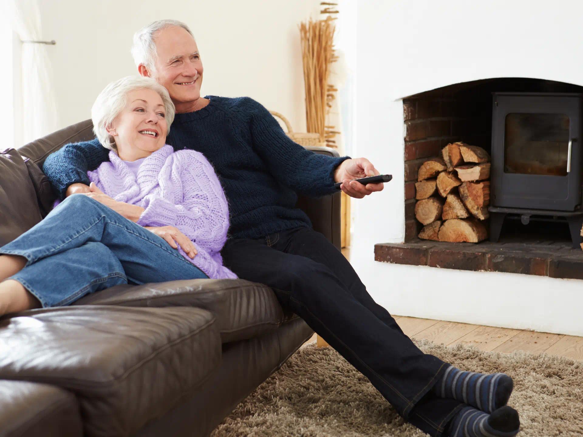 Couple watching TV with hearing aids